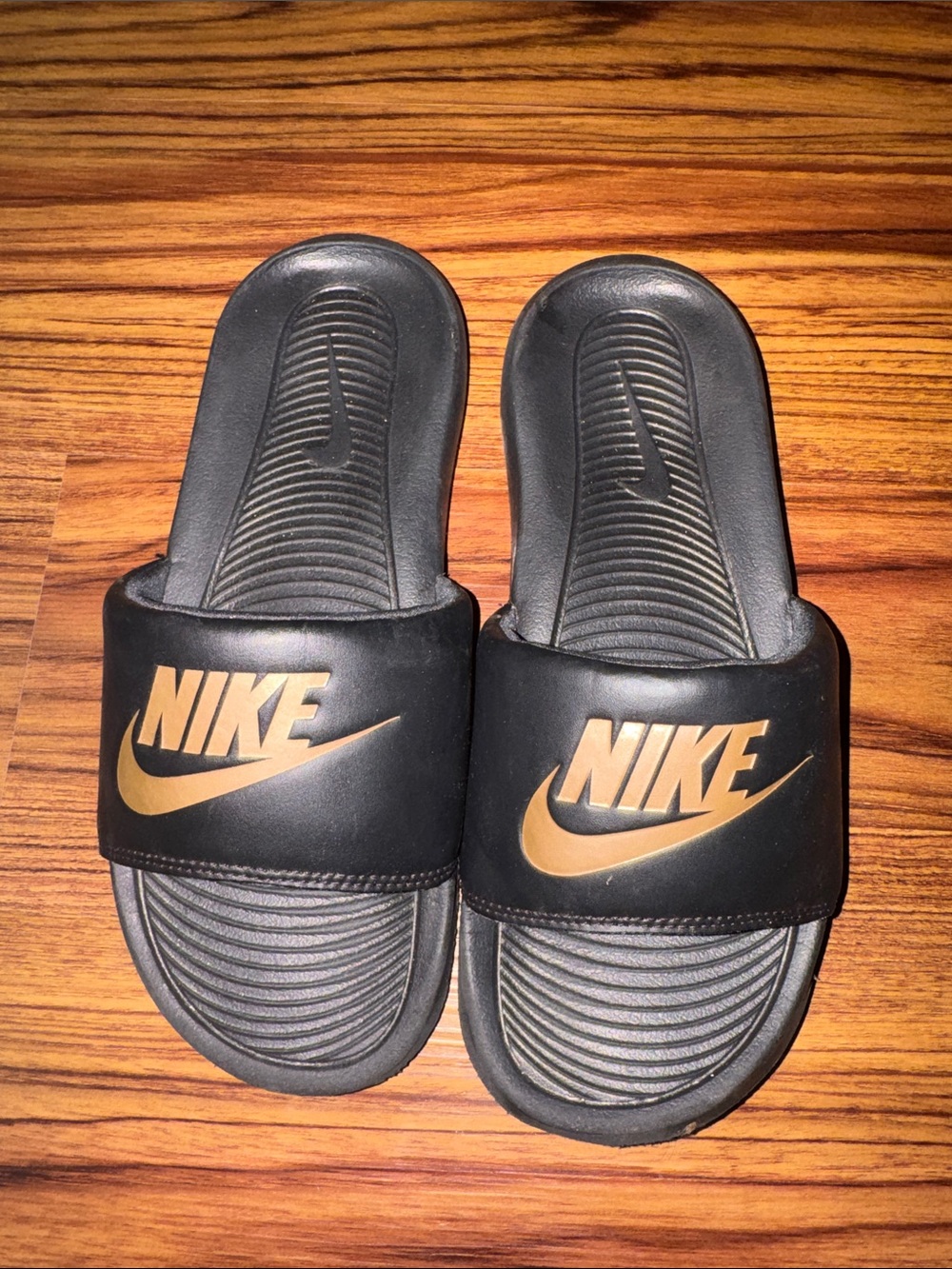 Nike Kids Black Slides with Gold Swoosh Logo